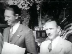 B/W 1932 close up WWI veterans with American flag walking past camera in Bonus March / Washington DC Stock Footage