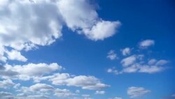 Time-lapse of white clouds against a blue sky Stock Footage