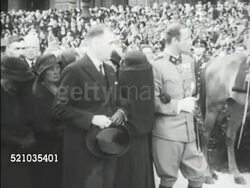 MOT 1934: DOLLFUSS FUNERAL: Procession w/ Caisson & coffin moving in streets, wife Alwine covered in black clothing walking w/ unidentified man & Ernst Rudiger prince von Staremberg Vice-chancellor, royalty & diplomats standing, casket & people walking Instructional Video