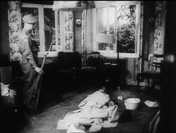 B/W 1945 soldier standing next to body of Himmler on floor after suicide / newsreel Stock Footage