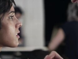 CU PAN Female makeup artist backstage at fashion show applying make-up  Stock Footage