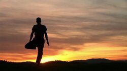 WS, Silhouette of man performing yoga against sky at sunset, rear view, Ljubljana, Slovenia Stock Footage