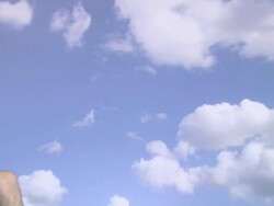 Zoom out from sky backdrop to show teenage couple in deckchairs Stock Footage
