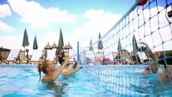 Friends playing volleyball in swimming pool. Stock Footage