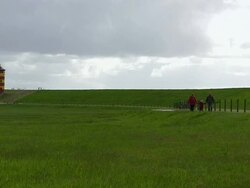 WS Family enjoing at Pilsum lighthouse near Krummhorn at North Sea (Eastern Friesland) / Lower Saxony Stock Footage