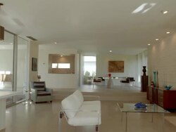 WS tracking across Cody designed mid-century modern living room with terrazzo flooring and fireplace Stock Footage