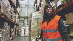 Woman moving boxes in a warehouse Stock Footage