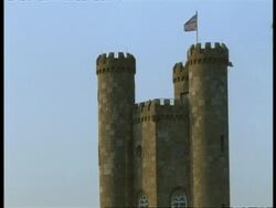 Broadway Tower, Gloucestershire - CU top turrets with British Union Jack flag flying on top Stock Footage