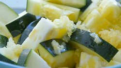 slices of courgette with minced garlic Stock Footage