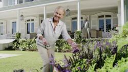Portrait of smiling senior woman gardening Stock Footage