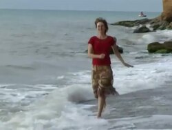 woman slowly running on the beach Stock Footage