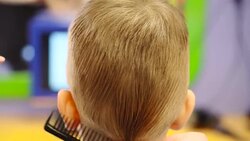 Hairdresser cutting cute childs hair Stock Footage