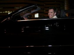 MS TU Well dressed young man sitting in drivers seat of his modern convertible car at night in urban area smiling / Minneapolis, Minnesota, United States Stock Footage