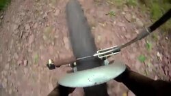 The front wheel of a bicycle steers down a rocky mountain path. Stock Footage