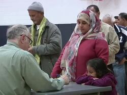 November 2, 2010 MS Voters from the Arab community  in Dearborn, Michigan sign in to receive their ballots for the midterm election at Salina School in the 14th Congressional District  / Dearborn, Michigan, United States Stock Footage