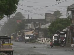 Strong winds blow through streets of Aparri as typhoon Megi or Juan approaches. Super Typhoon Megi or Juan, NE Luzon, Philippines Oct 2010 / AUDIO Stock Footage