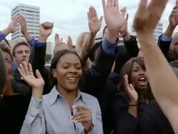 Slow motion medium shot pan point of view crowd of smiling businesspeople cheering and clapping / high fiving with hand Stock Footage