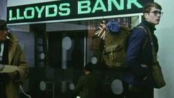 1969 PAN Some of the first passengers of the Ramsgate Hovercraft walking outside of Lloyd's Bank at the Pegwell Bay hoverport / Kent, England Stock Footage