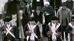 Villagers chant as French soldiers stand guard as they wait for the beheading of Marie Antoinette. Stock Footage
