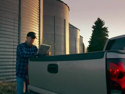 Farmer uses a digital tablet to access the internet Stock Footage