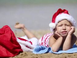 Baby Santa Claus on the beach Stock Footage