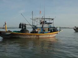 WS Man Prepping His Fishing Boat / Vietnam Stock Footage