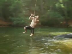 WS TS View of man on rope swinging above lake / Cape Town, South Africa Stock Footage