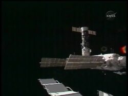 The Space Station crew takes a short hop in space Tuesday readying for a cargo mission News Clip