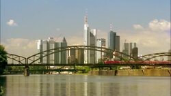 A train crosses a bridge over the Main River in Frankfurt, Germany. Stock Footage