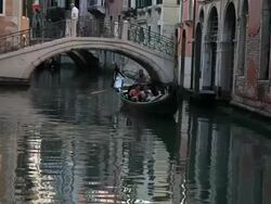 WS LD Gondola Floating down Canal in Front of Bridge / Venice, Italy Stock Footage