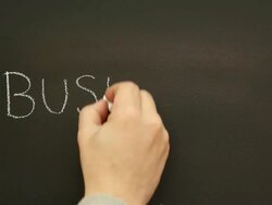 Writing 'Business' on the school blackboard Stock Footage