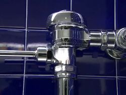 A man's hand flushes a public toilet. Stock Footage