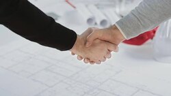 SLO MO Men shaking hands over the floor plan Stock Footage