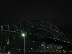T/L MS ZO Swimmers do laps in North Sydney Olympic Pool underneath the Sydney Harbour Bridge, Australia / Sydney, New South Wales, Australia Stock Footage
