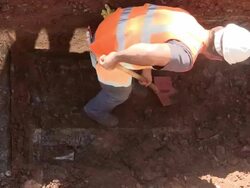 MS Shot of workmen digging on road at sewage pipe / Saarburg, Rhineland Palatinate, Germany Stock Footage