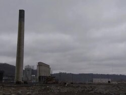 WS Tall smokestack at an old power plant is demolished using explosives and falling / Weirton, West Virginia, USA Stock Footage