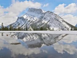 T/Lof clouds streaking by mountain landscape Stock Footage
