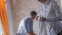 Restaurant staff sets tables and polishes glasses in dining room Stock Footage