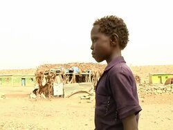 Boy who went through teeth ritual walking through village Stock Footage