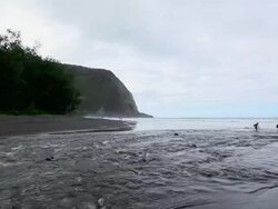 WS View of mother and daughter crossing waipio river with Waipio valley in background / Waipio, Waipio valely, Hawaii, The Big Island, USA Stock Footage