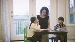 Mother helping children with homework Stock Footage