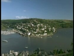 T/L WA high angle view of River Dart leading out to sea, Pan left to Kingsbridge Town, Dartmouth, boats and ferries on river and in harbour Stock Footage