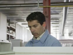 worker in furniture factory, manoeuvring piece of furniture on assembly line Stock Footage