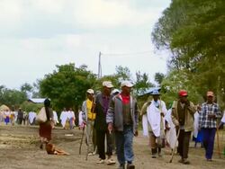 MS Tribe people waliking to local funeral at church / Melka Country, Ethiopia Stock Footage
