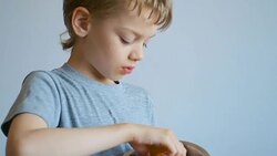 boy eating a peach, close up Stock Footage