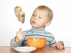 little boy eats with a fork Stock Footage