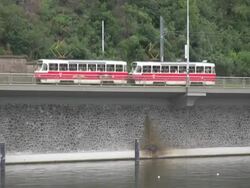 European Commuters: Trams Across River Stock Footage