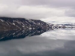 WS AERIAL View of clouds over snowy mountain and landscape with Lake Oskuvatn / Iceland Stock Footage