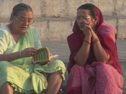 MS Two women sitting on the bank of Ganges river reading a book / Kashi, Uttar Pradesh, India Stock Footage