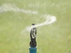 Water sprinkler showering grass Stock Footage